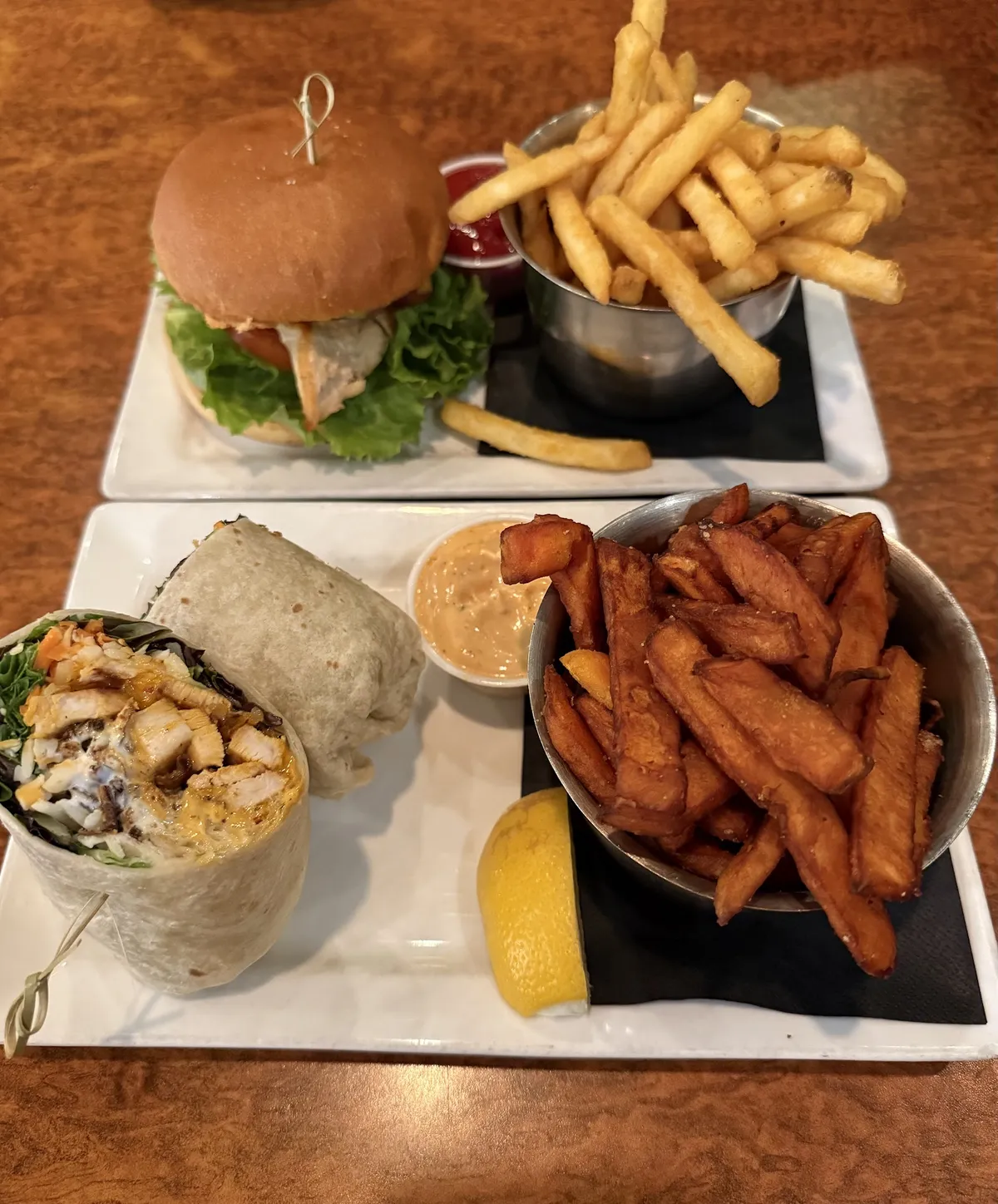 Burger with fries and chicken wrap with sweet potato fries